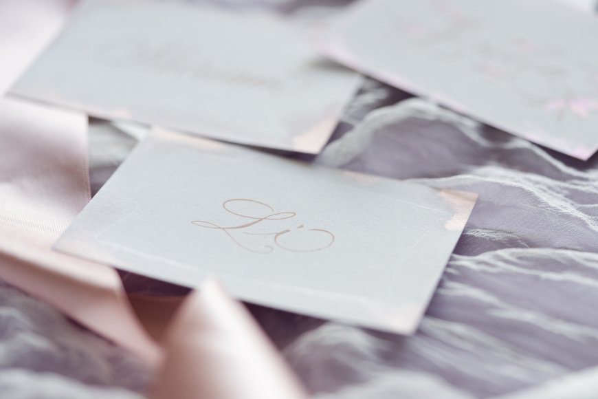 Kalligrafie in rosa auf schimmernden Tischkarten