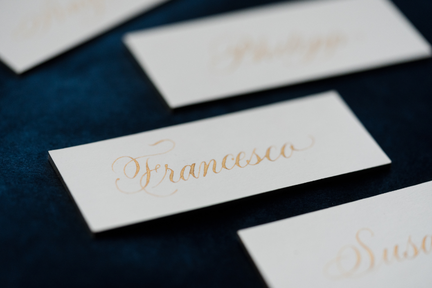 Beautifully calligraphed placecards with gold writing