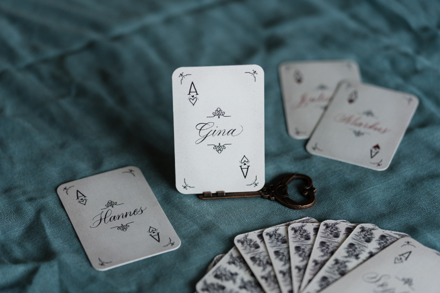A small playing card as a place card with calligraphy on it